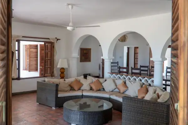 Living room with Swahili arches and a large rattan corner sofa